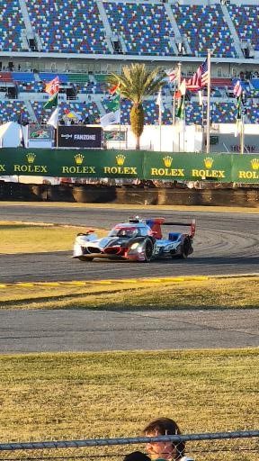 A GTP prototype through the International Horseshoe at the Rolex 24 in the golden evening light